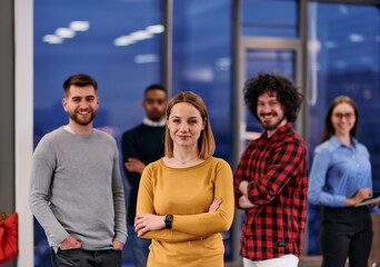 Portrait of successful creative business team looking at camera and smiling. Diverse business people standing together at startup. Selective focus 