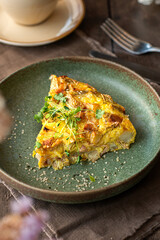 Slice of  Spanish zucchini tortilla on a ceramic plate. Brunch food.