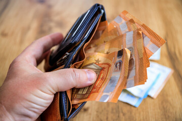 A man counting his savings in euros