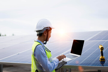 Engineer standing in solar power station looking sunrise