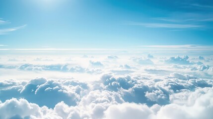 Fototapeta premium Serenity of white clouds against a bright blue sky with sunlight.