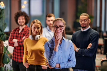 Obraz premium Portrait of successful creative business team looking at camera and smiling. Diverse business people standing together at startup. Selective focus 