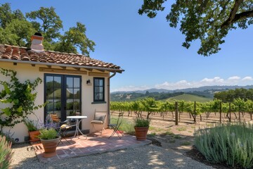 Obraz premium Charming Vineyard Cottage with Grape Vines and Rolling Hills Ideal for Wine Country Escape