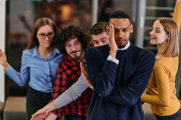 A group of young business people have fun playing interesting games while taking a break from work in a modern office. Selective focus 