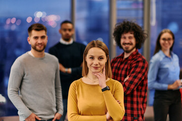 Portrait of successful creative business team looking at camera and smiling. Diverse business people standing together at startup. Selective focus 