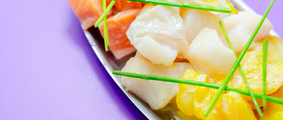 A plate of seafood and lemon on the metal tray