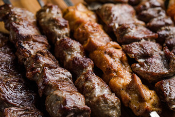Marinated shashlik preparing on a barbecue grill over charcoal. Shashlyk (skewered meat) was originally made of lamb. Roast Beef Kebabs On BBQ Grill.