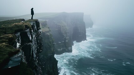 A figure standing at the edge of a cliff, looking out over the vast ocean, with wind ruffling their clothes
