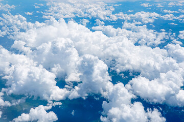 Landscape of beautiful fluffy puffy white cumulus clouds on blue sky background, top view