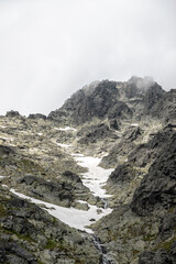 Tečúci  prameň po horskej skale z topiaceho sa snehu a ľadu