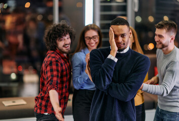 A group of young business people have fun playing interesting games while taking a break from work in a modern office. Selective focus 
