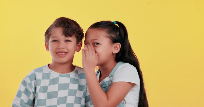 Girl, boy and children with whisper in studio with story, secret and talking by yellow background. Kids, friends and listen to gossip with news, conversation and playful with face, game and memory