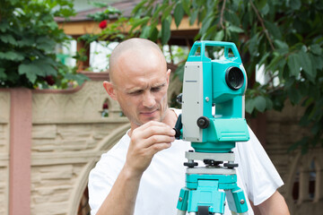 An engineer at work with a total station device