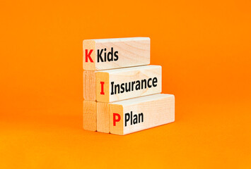 Naklejka premium KIP kids insurance plan symbol. Concept words KIP kids insurance plan on beautiful wooden blocks. Beautiful orange background. Business KIP kids insurance plan concept. Copy space.