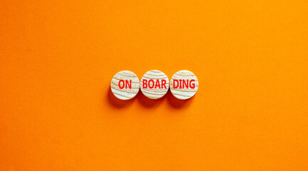 Onboarding success symbol. Concept word Onboarding on wooden circles. Beautiful orange background. Business onboarding success concept. Copy space.