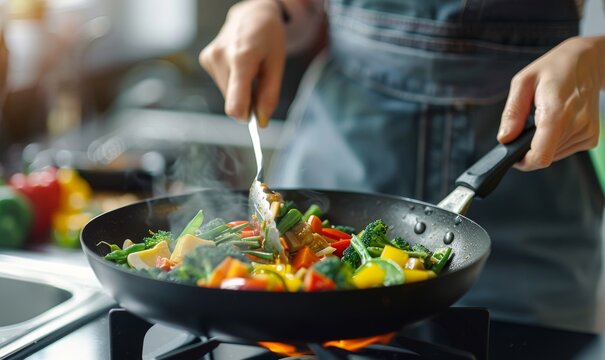 close up of hands cooking vegetables in a wok on a stove at home, using fork and spoon, colorful vegetable mix, healthy breakfast, high quality photo, blurred background