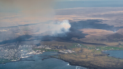 Icelandic landscape with smoke from volcano Grindavik, airial view from the airplane
