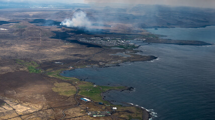 Icelandic landscape with smoke from volcano Grindavik, airial view from the airplane

