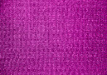 close up pink color fabric texture. fabric herringbone, zigzag, chevron pattern. purple upholstery...