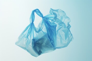 Fototapeta premium A blue plastic bag suspended by a string, often used for carrying groceries or other items