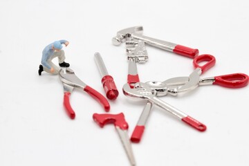 miniature figurine of a repairman with different toy tools