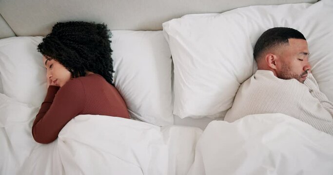 Conflict, sleeping and couple in bed for argument, disagreement or relationship problem in bedroom. Top view, pillow and tired woman with man for misunderstanding, ignoring or exhausted in home