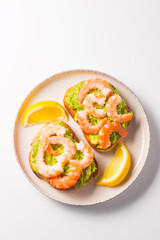 Shrimps on toast or sandwich with avocado and lemon. Breakfast concept. Bruschetta. 