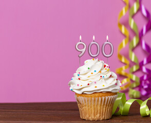 Birthday Cupcake With Candles Lit Forming The Number 900