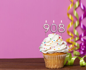 Birthday Cupcake With Candles Lit Forming The Number 908