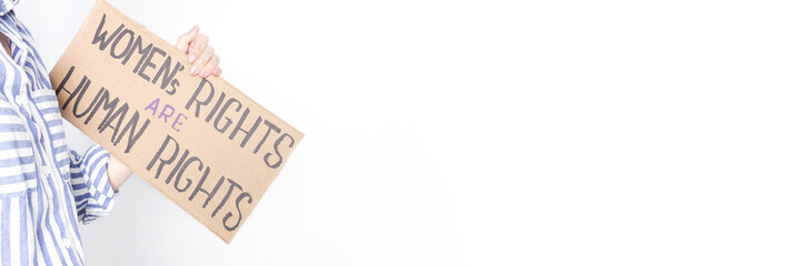 Woman holding a sign with the text Womens Rights are Human Rights on a white background
