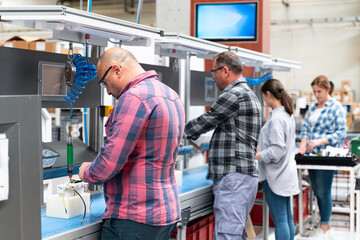 Manuel workers team work on production line with screw tool at factory