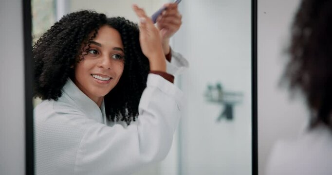 Beauty, brushing hair and mirror with woman in bathroom of home for daily or morning routine. Comb, hairbrush and reflection with smile of happy person in apartment for grooming or haircare treatment