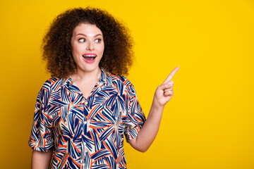 Photo portrait of attractive young girl point look excited empty space dressed stylish colorful clothes isolated on yellow color background