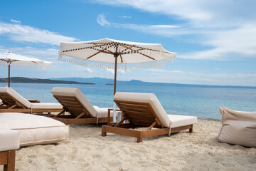 luxurious sunbeds and umbrellas on a beautiful beach