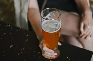 holding by hand dark beer against the background of watching Euro 2024 football championship