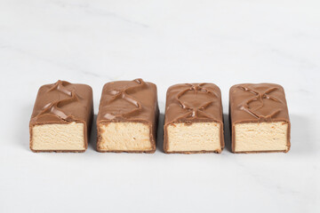 Candy bar. Milk souffle. In chocolate. Close-up