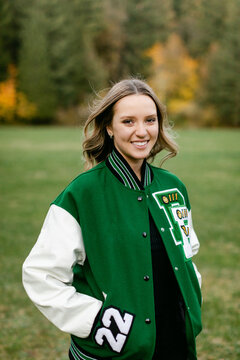 Smiling Teen Wearing Letterman's Jacket