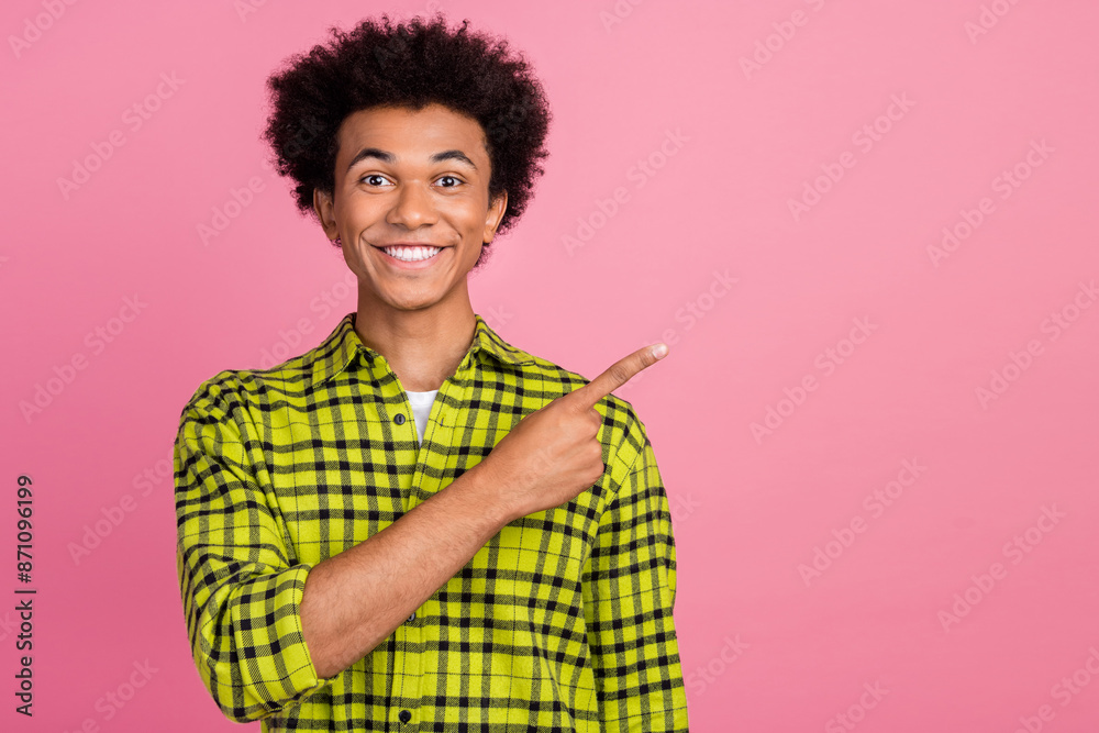 Poster Photo of nice young man direct finger empty space wear shirt isolated on pink color background