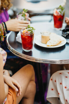 girlfriends with red cocktails 