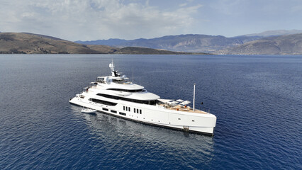 Aerial drone top down photo of luxury yacht nose with wooden deck anchored in paradise exotic deep blue sea island bay © aerial-drone