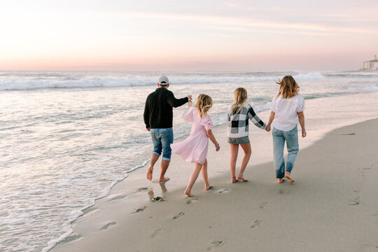 Happy Family with teenagers on the beach together