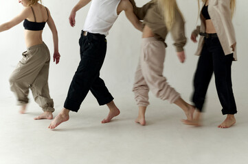 A dance group rehearsing on a white background

