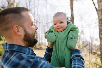 dad and infant daughter playing outdoors in yard