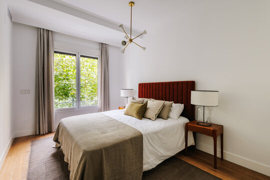Modern bedroom with large window that lets in plenty of natural light
