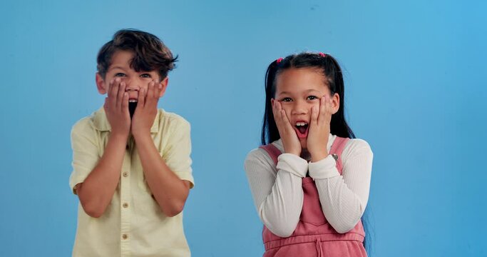 Shock, surprise and face of children on blue background for news, announcement and information. Youth, childhood and portrait of young kids with facial expression, emoji reaction and wow in studio