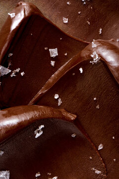 Waves of heavy chocolate ganache sprinkled with coarse salt flakes