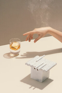 A women's hand reaching out for a whisky