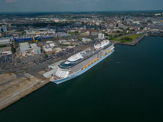 Naklejka premium Large cruise ship moored at Southampton UK. Panoramic view of the urban Southampton city with cruise ship terminal. High altitude aerial on a sunny day.