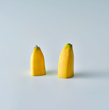Two banana half on blue background