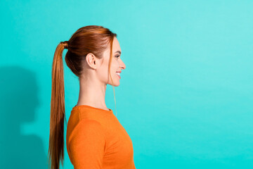 Side profile photo of nice woman with foxy hairstyle wear orange crop top look at sale empty space isolated on turquoise color background